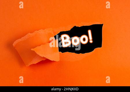 Torn hole paper orange color with copy space for text halloween Stock Photo