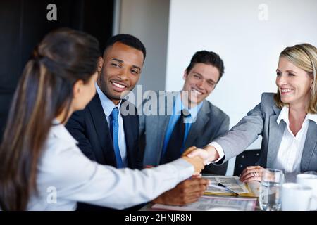 We hope to see you on Monday. Shot of professional coworkers shaking hands during a meeting in the office. Stock Photo