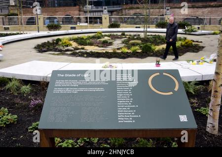Manchester, UK, 17th February, 2022. A man looks at the Glade of Light memorial: a white marble ‘halo’ bearing the names of those killed in the 22nd May 2017 bombing. The Manchester Arena Inquiry has heard that MI5 had intelligence to assess Salman Abedi as a threat to national security and open an investigation before he carried out the bombing on 22nd May 2017, killing 22 people and injuring hundreds. Credit: Terry Waller/Alamy Live News Stock Photo