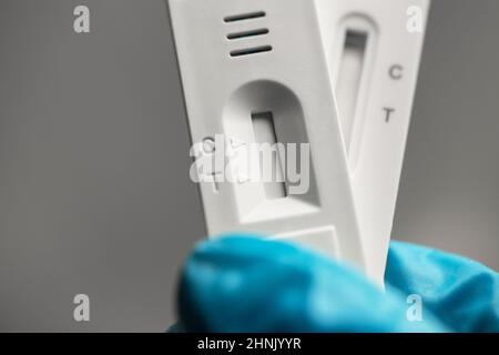 some covid-19 antigen rapid tests in a hand with a medical glove Stock Photo