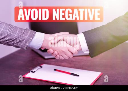 Hand writing sign Avoid Negative, Business approach Staying away from pessimistic showing Suspicious Depression Two Professional Well-Dressed Corporat Stock Photo