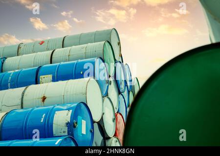 Old chemical barrels stack. Red, green, and blue chemical drum. Steel tank of flammable liquid. Hazard chemical barrel. Industrial waste. Empty chemical barrels at the factory warehouse. Hazard waste. Stock Photo