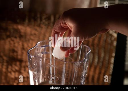 Adding Ice Cubes to Blender Stock Photo