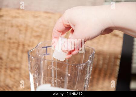 Adding Ice Cubes to Blender Stock Photo