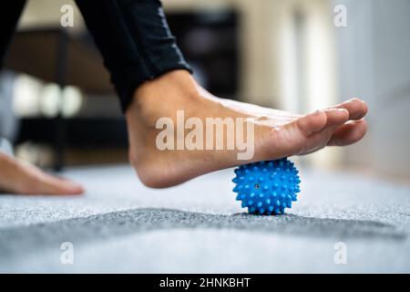 Feet Massage Using Trigger Point Spiky Massage Ball. Myofascial Release Stock Photo