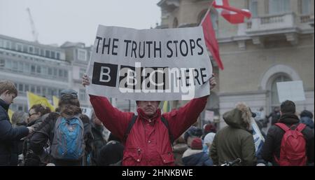 A man protester holding a banner, ‘The Truth Stops BBC Here’, at Portland Place, in preparation for the ‘World Wide Rally For Freedom’. Stock Photo