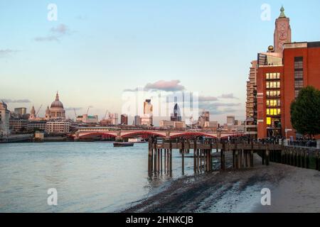 London, United Kingdom - October 7th, 2006:  Thames Riverside in the evening, Blackfriars Bridge and St. Paul Cathedral in the background, people enjoying warm autumn afternoon under OXO tower. Stock Photo