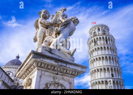 Pisa, Italy. Campo dei Miracoli with Putti Fountaind and Leaning Tower, world famous attraction in Tuscany. Stock Photo