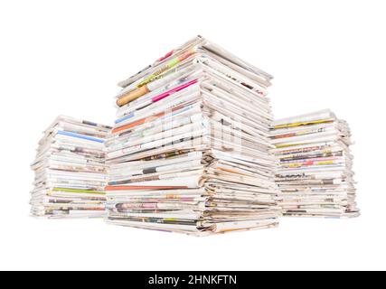 Three big stacks of newspapers isolated on white background Stock Photo