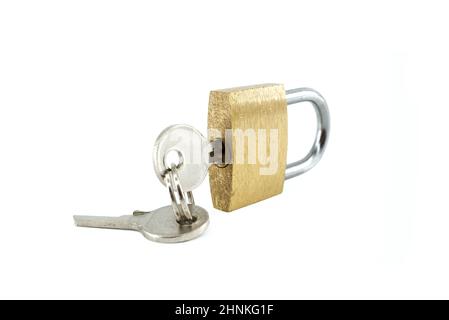 Brass lock with with keys in the hole isolated on the white background Stock Photo