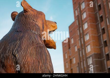 head of wooden bear on background of apartment house Stock Photo