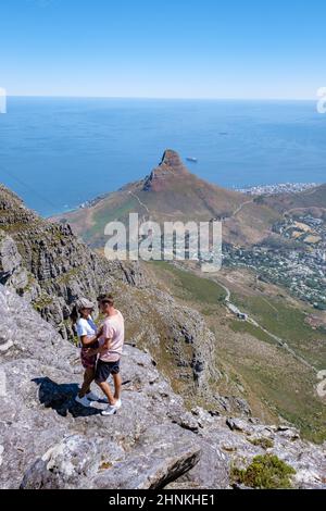 view from the Table Mountain in Cape Town South Africa, view over the ocean, and Lion's Head from Table Mountain Cape Town. couple man and woman on top of mountain Stock Photo