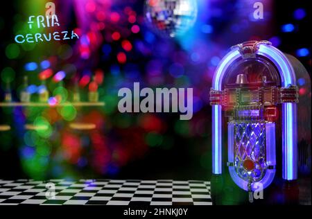 Jukebox in Bar with Disco Ball and Bokeh Composite Image Stock Photo