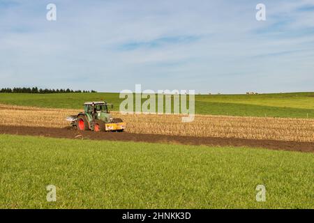 Tractor plowing in the field Stock Photo