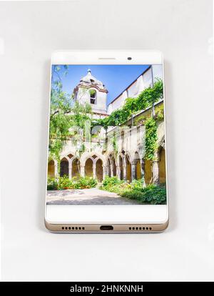 Modern smartphone displaying full screen picture of a cloister, Italy Stock Photo