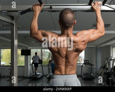 Male Athlete Doing Pull Ups Stock Photo