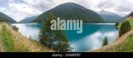 In the alpine valley of Schanlstal, South Tyrol, the colorful lake of Vernago Stock Photo