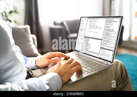 Computer Programmer Writing Program Code On Computer In Office Stock Photo