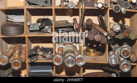 Metal bolts and nuts in the work shelf. various fasteners Stock Photo