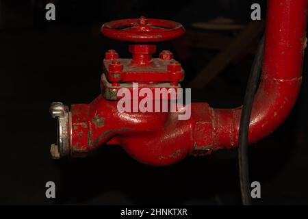 Red valve installed at fire hydrant pipe Stock Photo