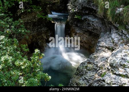 the small waterfalls of a stream that flows through the woods Stock Photo