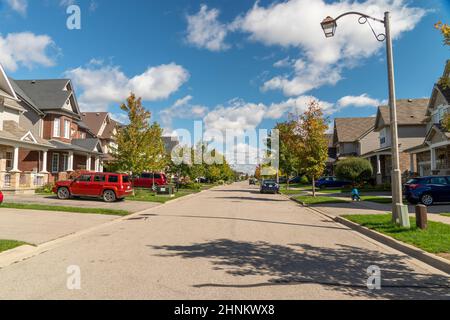 Road without transport on weekends under a blue sky with beautiful autumn clouds Stock Photo