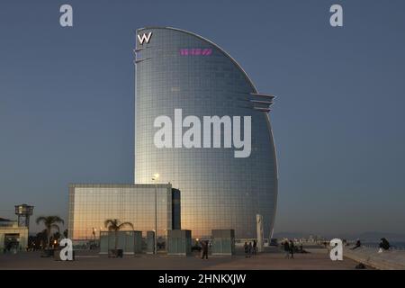 W Barcelona Hotel - Hotel Vela (Sail Hotel) modern glass landmark building at dusk, located in Barceloneta district of Barcelona Spain. Stock Photo