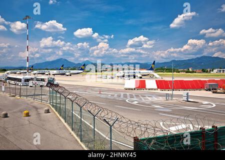 Bergamo Orio Al Serio airport airplanes and town of Bergamo view. Stock Photo