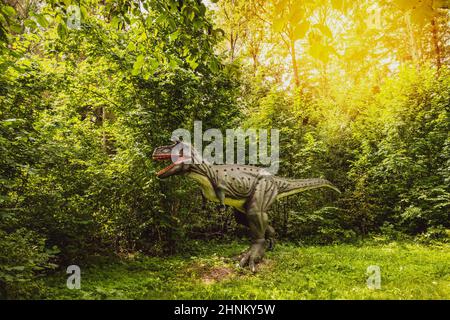 Statue of realistic dinosaur in a forest Stock Photo