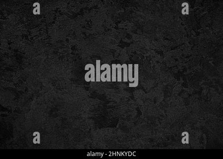 Texture of black decorative plaster or concrete. Abstract grunge background for design. Stock Photo