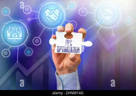 Text caption presenting Ppc Optimization, Word Written on Enhancement of search engine platform for pay per click Hand Holding Jigsaw Puzzle Piece Unl Stock Photo