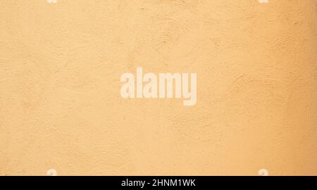 Yellow orange Beige painted stucco wall construction. Pattern Background texture. Stock Photo