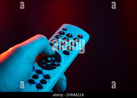 Hold remote control in hand Stock Photo