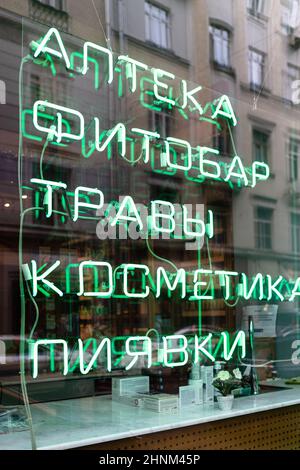 glowing green neon inscription in pharmacy window Stock Photo