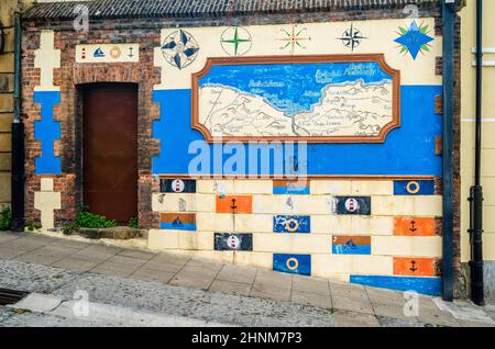 PORTUGALETE, SPAIN - JULY 7, 2021: Colorful facade, old map painted on a wall in the old town of Portugalete, Basque Country, Spain Stock Photo