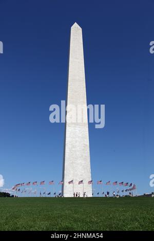 Washington Memorial showing circle of flags in blue sky Stock Photo