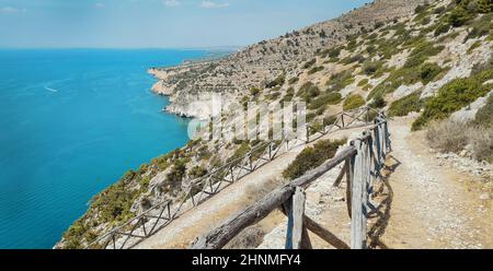 Panoramic summer view of Gargano coast with hiking trail near Marina of Mattinata, Puglia, Italy.  Beautiful marine scenery of  Adriatic sea. Travelin Stock Photo