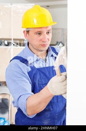 Plasterer working indoors Stock Photo