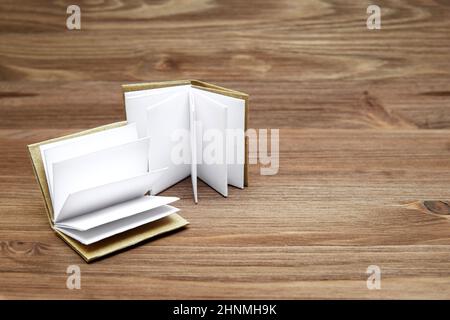 Two open blank pages miniature books on a wooden table. Stock Photo