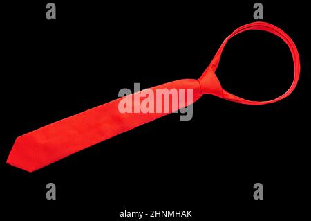 Tied red necktie isolated on black background. Stock Photo