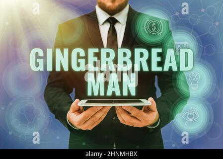 Text sign showing Gingerbread Man, Business showcase cookie made of gingerbread usually in the shape of human Man In Office Uniform Holding Tablet Dis Stock Photo