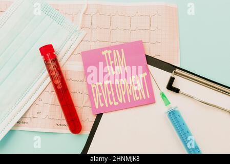 Text caption presenting Team Development, Business showcase learn why and how small groups change over time with graphs Reading Graph And Writing Impo Stock Photo