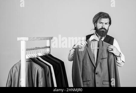 Shopper hipster man in fitting room menswear store, try on a suit concept Stock Photo