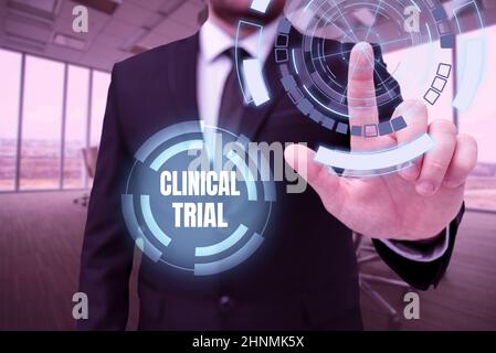 Text showing inspiration Clinical Trial, Word for trials to evaluate the effectiveness and safety of medication Man In Office Uniform Standing Pressin Stock Photo