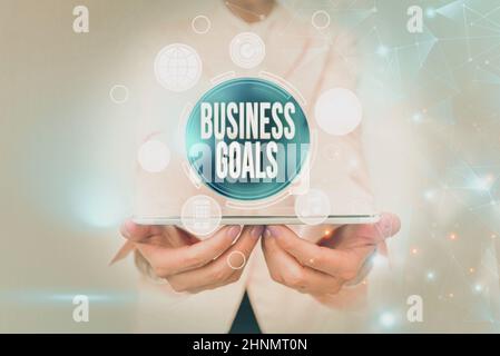 Handwriting text Business Goals, Internet Concept Expectation to accomplish over a specific period of time Business Woman Touching Futuristic Virtual Stock Photo