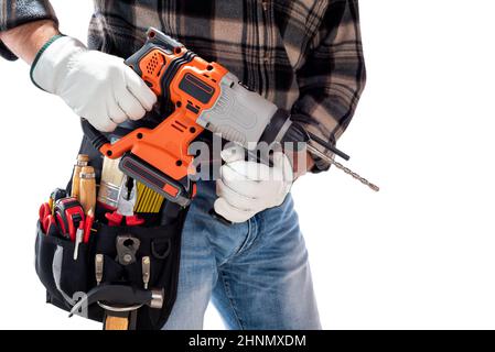 Carpenter worker at work holding rechargeable hammer drill, isolated on white background. Construction industry. Carpentry. Stock Photo