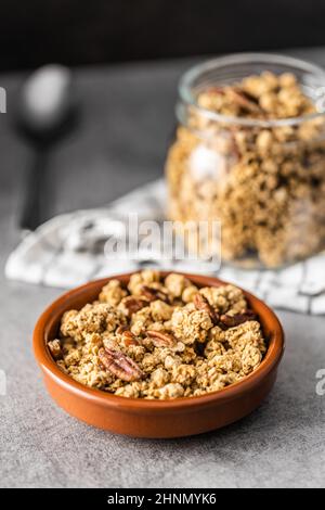 Sweet granola cereals in bowl on kitchen table. Stock Photo