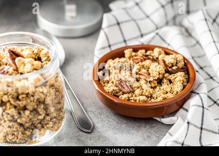 Sweet granola cereals in bowl on kitchen table. Stock Photo