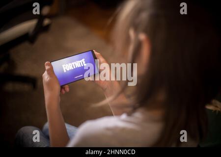 Illustrative editorial image of child playing Fortnite Stock Photo