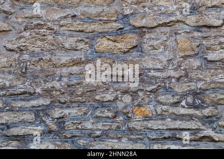 Background from a historic stone wall. Stock Photo